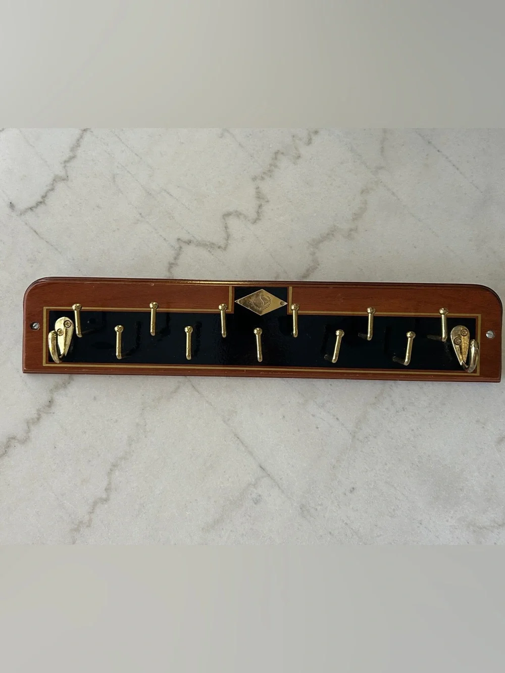 Vintage Wall-Mounted Tie Rack with Gold Hooks and Black Accent